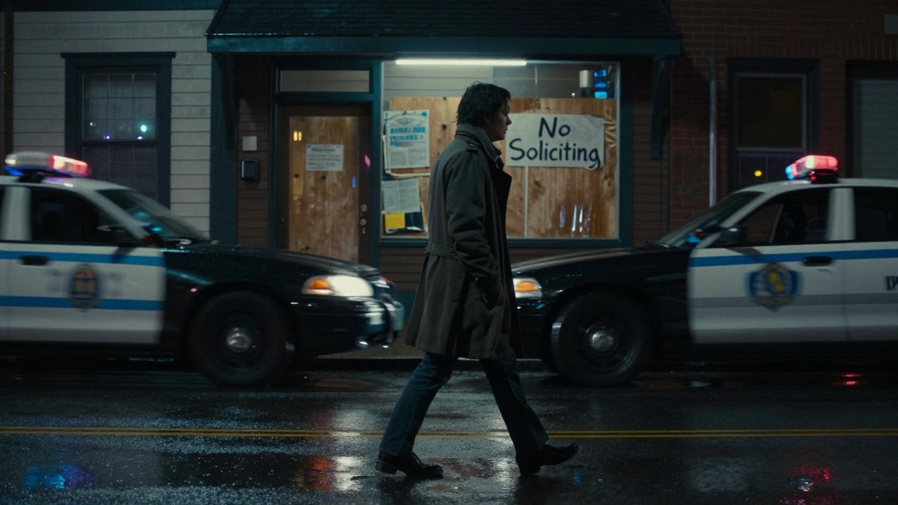 Person walking alone in rainy Newport street at night, police car passing, faded &#039;No Soliciting&#039; sign on door.